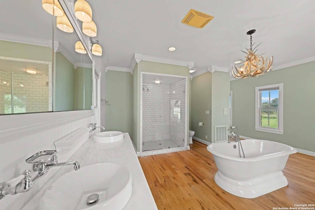 full bathroom with wood-type flooring, shower with separate bathtub, crown molding, and toilet