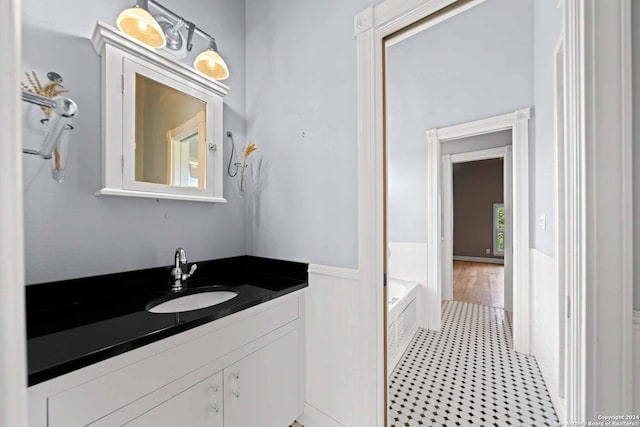 bathroom featuring vanity and a bath