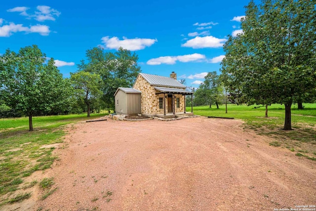 exterior space featuring a front yard and a shed