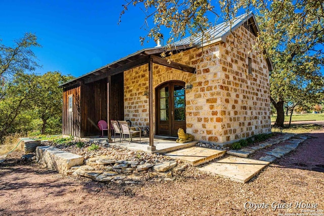 rear view of property featuring french doors and a patio area