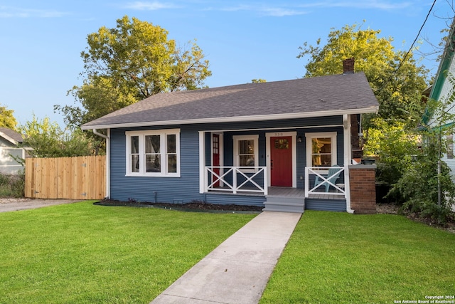 bungalow with a front lawn and covered porch