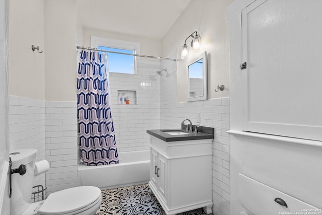 full bathroom featuring shower / bathtub combination with curtain, tile walls, vanity, and toilet