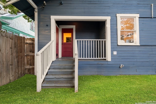 doorway to property featuring a yard