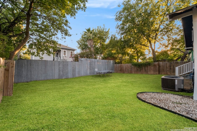 view of yard with a trampoline and cooling unit