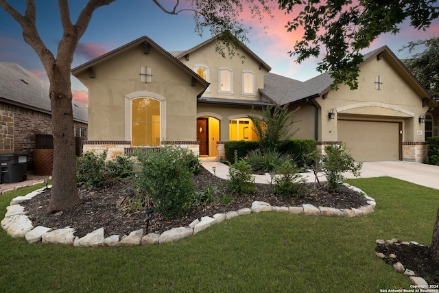 view of front of home with a lawn and a garage