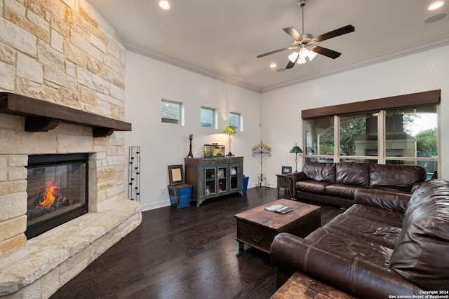 living room with ceiling fan, crown molding, a fireplace, and dark hardwood / wood-style flooring