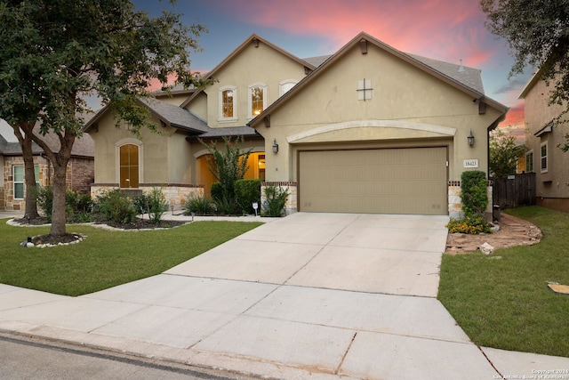 view of front facade with a garage and a yard