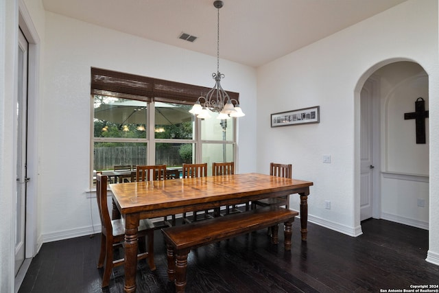 dining room with a notable chandelier and dark hardwood / wood-style floors