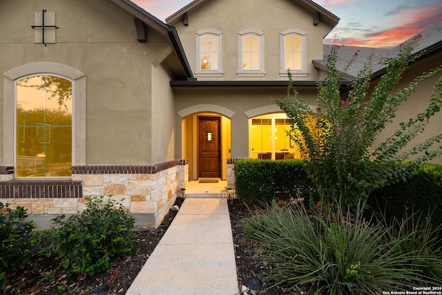 view of exterior entry at dusk