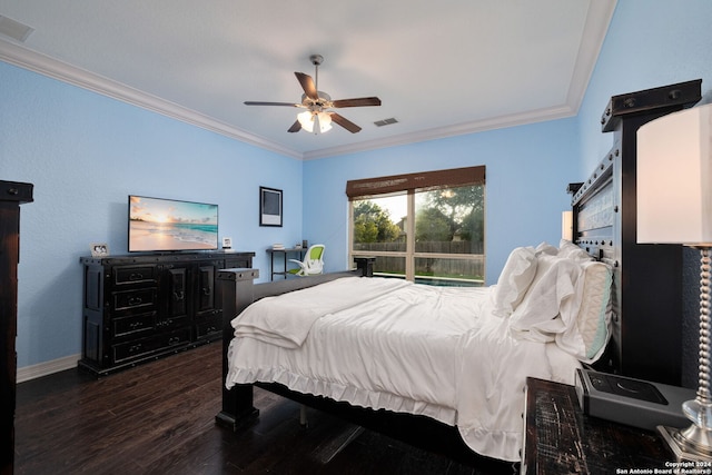 bedroom featuring ceiling fan, dark hardwood / wood-style floors, and crown molding