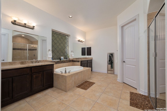 bathroom with plus walk in shower, tile patterned floors, and vanity