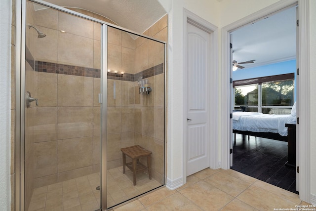 bathroom with tile patterned floors, ceiling fan, and an enclosed shower