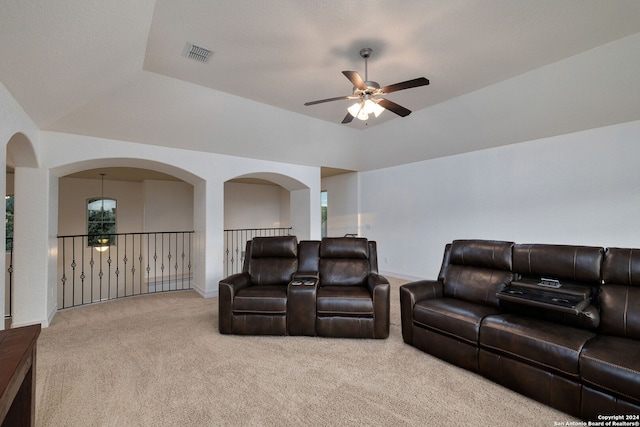 home theater featuring ceiling fan with notable chandelier and light colored carpet