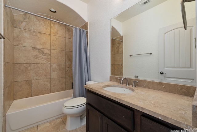 full bathroom with shower / bathtub combination with curtain, tile patterned flooring, vanity, and toilet