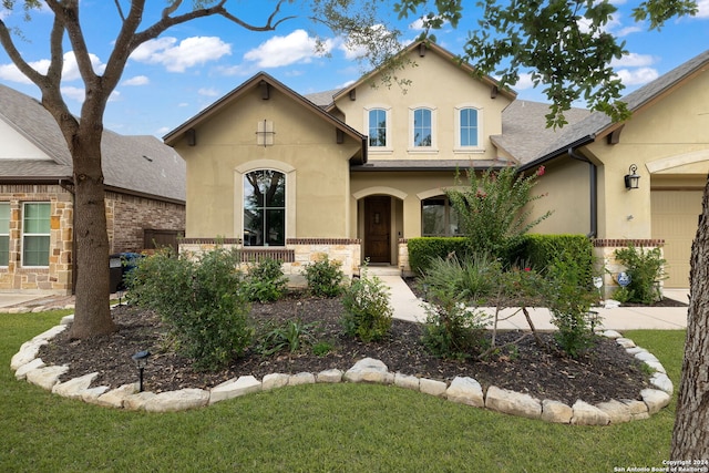 view of front of property with a garage and a front lawn