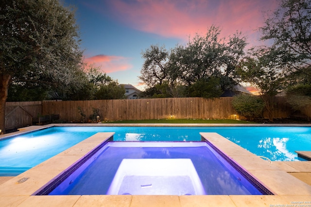 view of pool at dusk