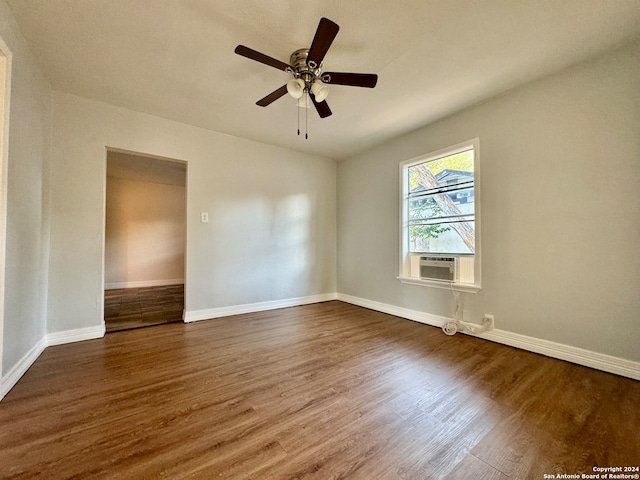 empty room featuring dark wood-type flooring and ceiling fan