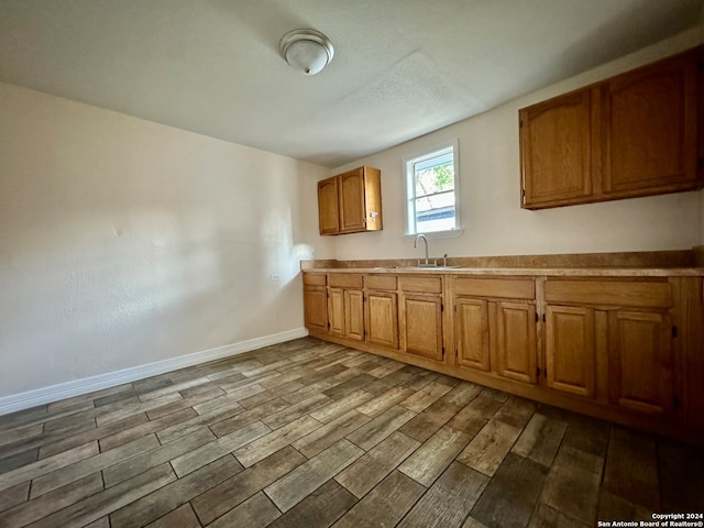 kitchen with sink and light hardwood / wood-style floors