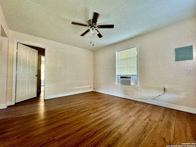 unfurnished living room with ceiling fan, cooling unit, and dark hardwood / wood-style floors