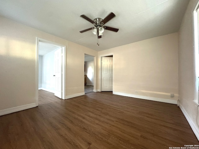 spare room with ceiling fan and dark wood-type flooring