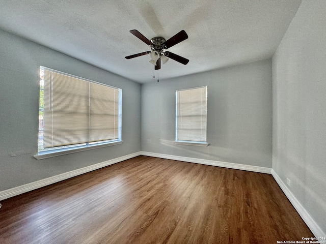 spare room featuring a textured ceiling, ceiling fan, and hardwood / wood-style flooring