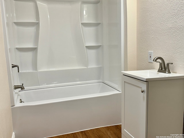 bathroom featuring bathing tub / shower combination, hardwood / wood-style flooring, and vanity