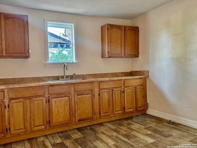 kitchen with light hardwood / wood-style flooring and sink