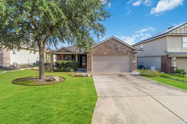 ranch-style home with cooling unit, a garage, and a front yard