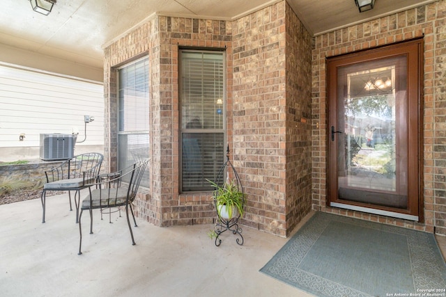 property entrance with cooling unit and a patio area