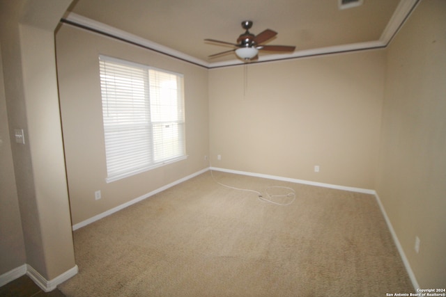 spare room with carpet flooring, ceiling fan, and a wealth of natural light