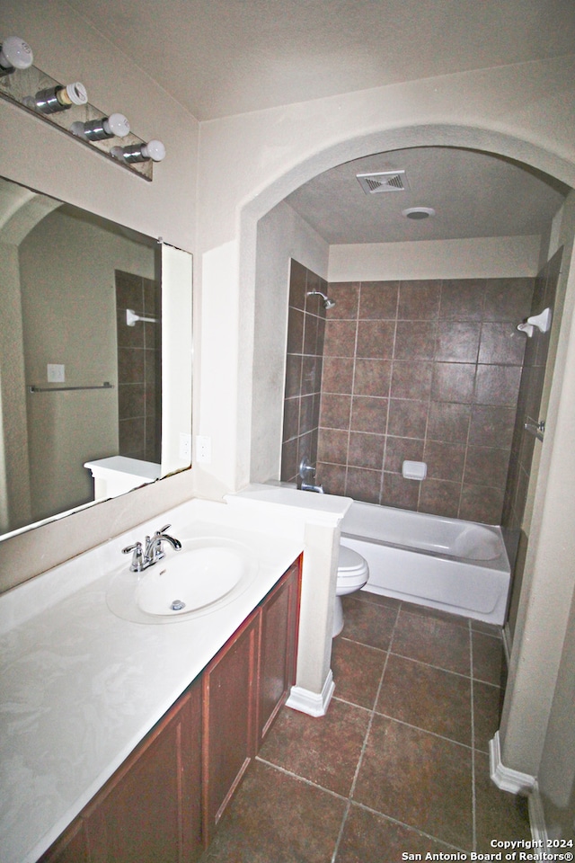 full bathroom with vanity, toilet, tile patterned floors, and tiled shower / bath