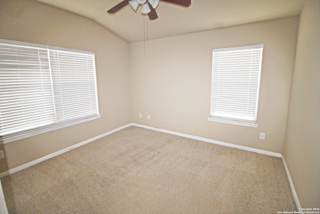 unfurnished room with ceiling fan, lofted ceiling, carpet, and a healthy amount of sunlight