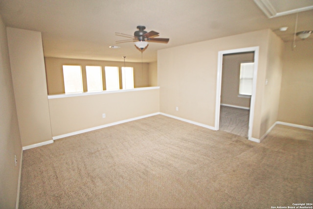 spare room with ceiling fan and carpet floors