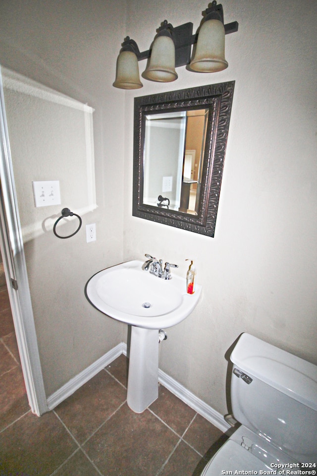 bathroom featuring tile patterned flooring and toilet