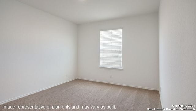 unfurnished room featuring light colored carpet