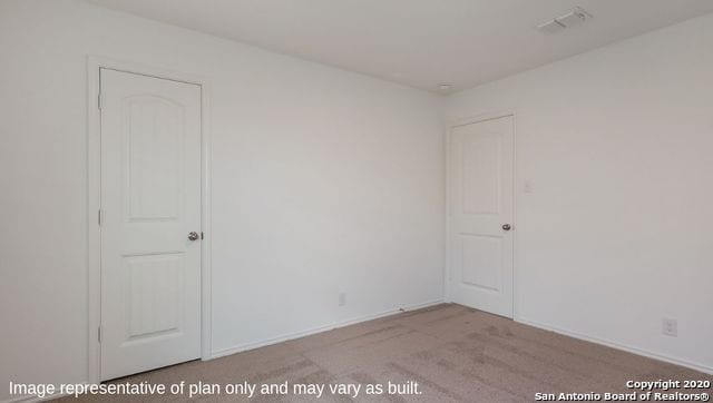 unfurnished room featuring light colored carpet