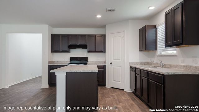 kitchen with a kitchen island, dark hardwood / wood-style flooring, dark brown cabinetry, black range, and sink