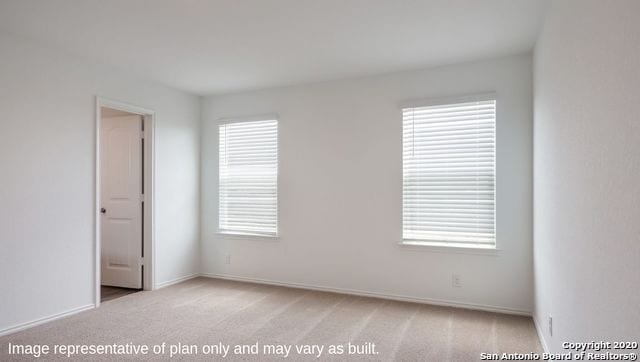 unfurnished room with light carpet and plenty of natural light