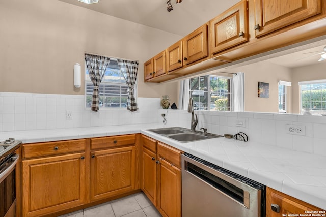 kitchen with dishwasher, sink, and a wealth of natural light