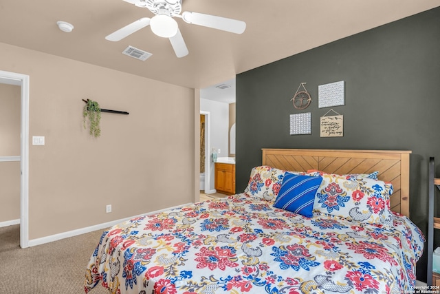 bedroom with light carpet, ensuite bath, and ceiling fan