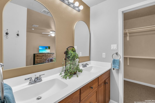 bathroom with ceiling fan and vanity