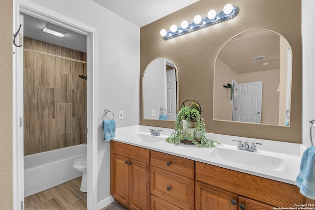 full bathroom featuring vanity, toilet, and tiled shower / bath