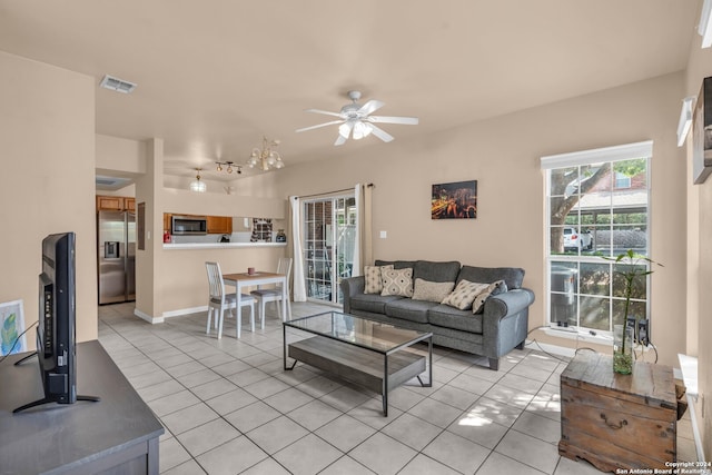 tiled living room featuring ceiling fan and a wealth of natural light