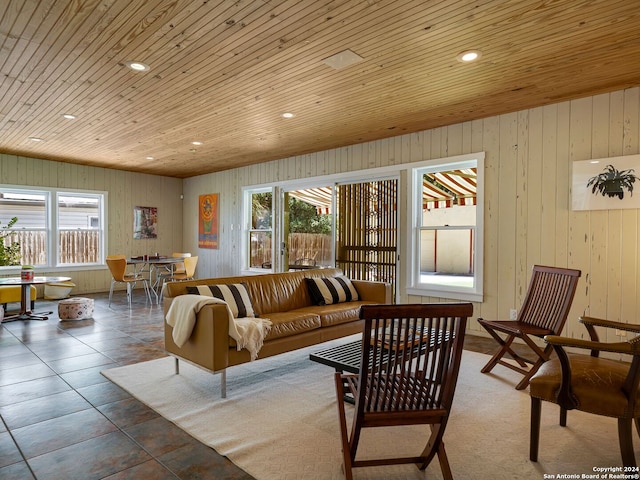 tiled living room featuring wooden walls and wooden ceiling