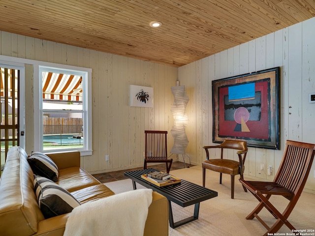 living room featuring wooden ceiling and wood walls