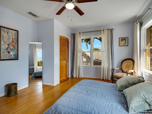 bedroom featuring ceiling fan, a closet, and light hardwood / wood-style flooring