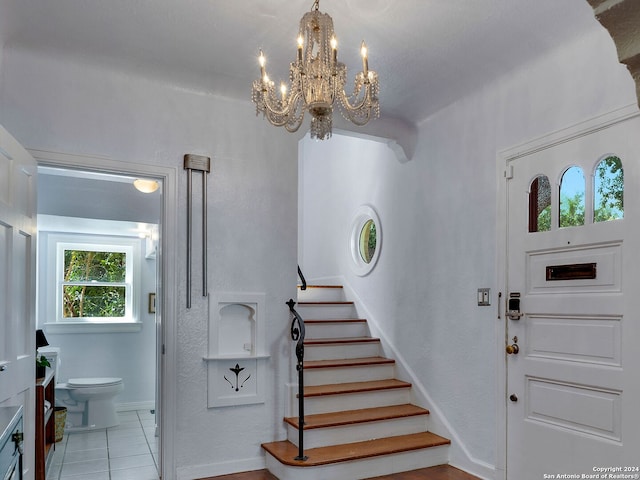 entrance foyer with an inviting chandelier and light tile patterned floors