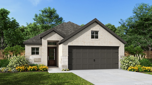 view of front of property with a garage and a front lawn