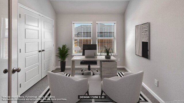 office area with carpet flooring and vaulted ceiling