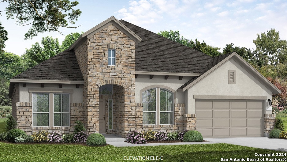 view of front of property featuring a garage and a front yard